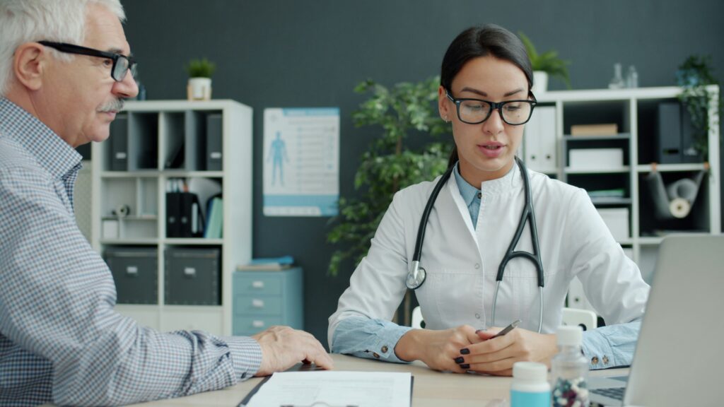 A caring doctor talking with an elderly patient during a diabetes consultation